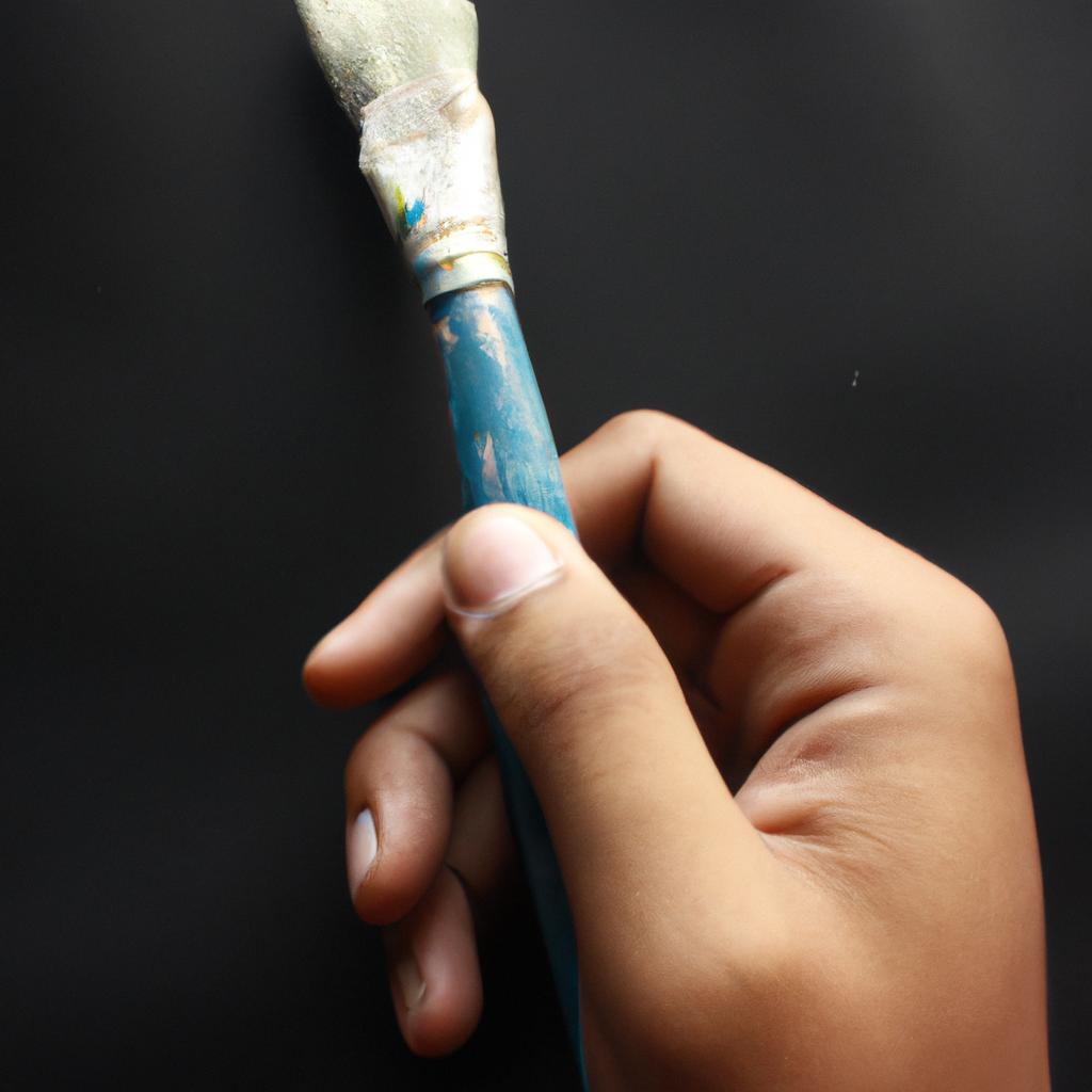 Person holding a paintbrush