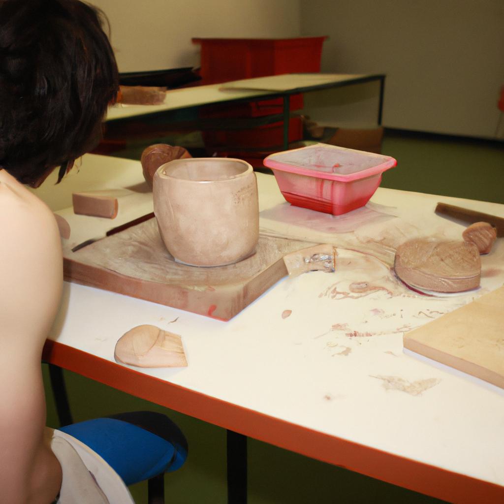 Person sculpting clay in studio